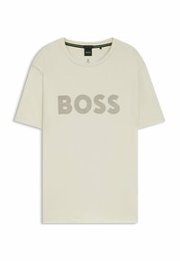 Beige lyhythihainen t-paita, jossa on pyöreä kaula-aukko ja etuosassa harmaasta keskeisestä viivasta tulostettu "BOSS"-teksti.
