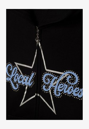 Black zip-up hoodie featuring "Local Heroes" in blue scripted lettering, outlined in silver with rhinestone accents, and a star graphic design.