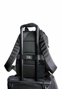Black travel backpack featuring ergonomic padded straps, a textured back, and a retractable handle for easy mobility on wheels.