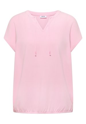 Blouse rose clair à manches courtes avec col en V, cordons à nouer, ourlet élastiqué et étiquette de marque "CECIL" à l'intérieur du col.