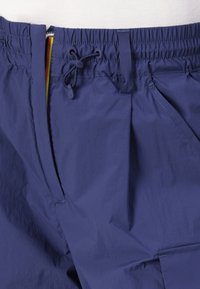 Navy blue shorts with a drawstring waist, featuring a smooth texture and a side pocket. The fabric appears lightweight and durable.