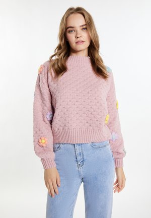 Rosa gestrickter Pullover mit strukturiertem Muster und bunten Blumenapplikationen an den Ärmeln. Figurbetonter Taillenschnitt, runder Halsausschnitt und gerippte Bündchen.