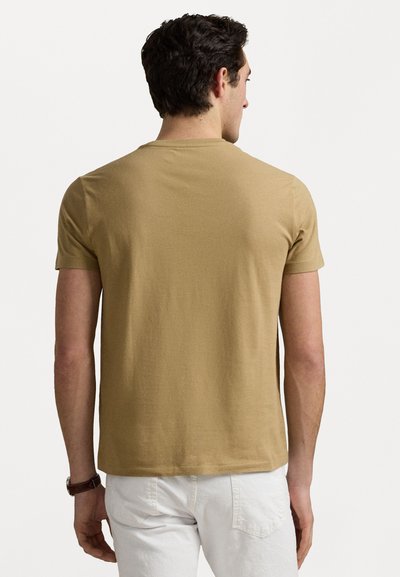 Short-sleeve, light brown t-shirt made of soft fabric. Features a crew neck and a relaxed fit, with a smooth texture and no visible patterns.