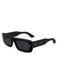 Black rectangular sunglasses with dark lenses, plastic frame, subtle silver accents on the temples, and a smooth surface texture.