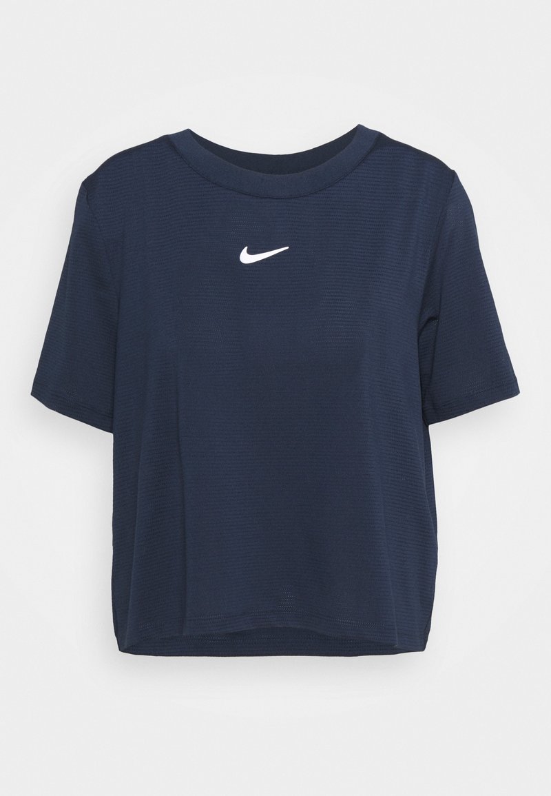 Marinblå kortärmad croppad t-shirt i texturerad tyg. Har en vit Nike-logga på bröstet och rund halsringning.