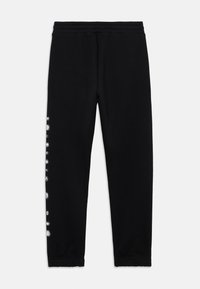 Schwarze Jogginghosen aus weichem Stoff, mit tailliertem Design, elastischem Bund und weißen runden Mustern an einer Seite.