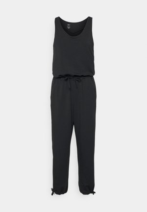 Czarny kombinezon z bezrękawowym topem, talią na sznurki i zwężanymi nogawkami. Posiada elastyczne mankiety z regulowanymi trokami. Miękka, elastyczna tkanina.
