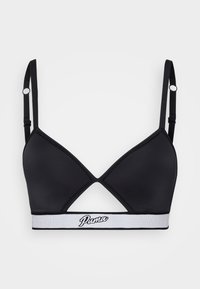 Black triangle bralette with adjustable straps, cut-out design, and wide white elastic band featuring "Puma" logo in black. Smooth fabric texture.
