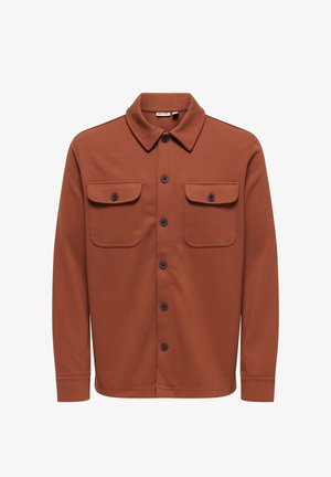 Rustfarget skjortejakke med knapper, to klaffelommer foran, spiss krage, lange ermer og svarte knapper midt foran.