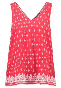 Haut rouge sans manches avec un col en V, présentant des motifs blancs de losanges et floraux, ainsi que des accents blancs complexes le long de l'ourlet.