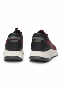 Athletic sneakers in burgundy mesh with black accents and a cream-colored sole. Features a pull tab and reflective detailing on the heel.