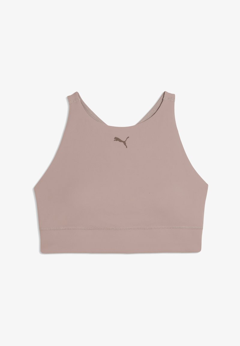 Hele roosa spordirinnahoidja, millel on sile ja veniv kangas ning ümar kaelus. Esiküljel keskel on väike pruun Puma logo.