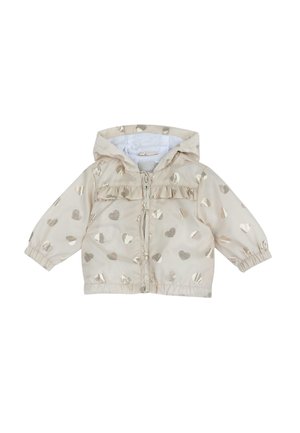 Giacca beige con motivi a cuore metallici dorati, chiusura con zip e dettaglio arricciato sul petto. Presenta un cappuccio integrato e polsini elasticizzati.