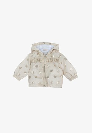 Beige jas met metallic gouden hartpatronen, ritsluiting en een gerimpeld detail op de borst. Voorzien van een aangehechte capuchon en elastische manchetten.
