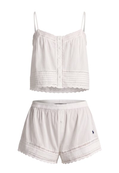White two-piece pajama set with spaghetti strap buttoned top and elastic waist shorts, both featuring lace trim and decorative stitching.