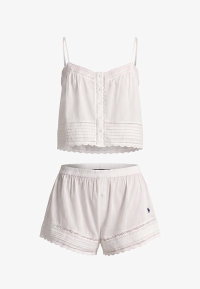 White two-piece pajama set with spaghetti strap buttoned top and elastic waist shorts, both featuring lace trim and decorative stitching.