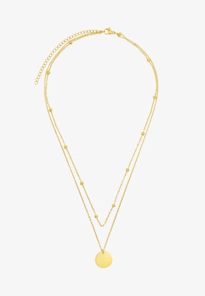 Collier à plusieurs couches en métal doré avec deux chaînes ornées de petites perles rondes et d'un pendentif circulaire. Texture lisse et design minimaliste.