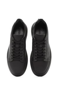Sneakers neri in pelle con punta rotonda, lacci piatti e dettagli testurizzati. Design minimalista e suola in gomma, con una finitura liscia.