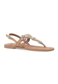 Tansfarbene flache Sandalen mit einem verstellbaren Riemen, die dekorative Perlen und Blumenmuster über dem Vorfuß aufweisen. Aus weichem Wildleder.