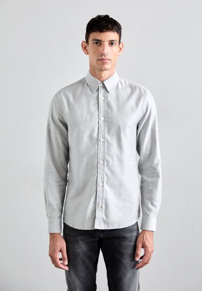 Lys grå skjorte med krave, lange ærmer og hvide knapper. Stoffet ser glat ud med en subtil tekstur.