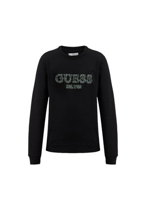 Felpa nera realizzata in cotone, con scollo rotondo, maniche lunghe e "GUESS EST. 1981" ricamato in verde sulla parte frontale.