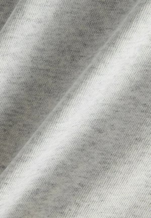 Light gray fabric with fine knit texture and soft folds creating subtle shadowing and depth.