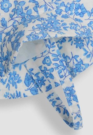 Blue floral fabric with small flowers and leaves on a white background. Features a binding edge and a looped tie. Soft, textured cotton.