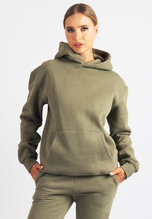 Olivno zelena jopa iz mehkega blaga, z žepom spredaj, dolgimi rokavi in velikim nastavljivim kapuco. Gladek videz, sproščen kroj.