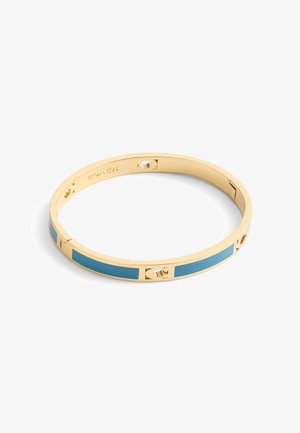 Bracelet jonc en doré avec une finition lisse, accents bleus en incrustation et découpes circulaires. Design minimaliste avec un mécanisme d'ouverture sécurisé.
