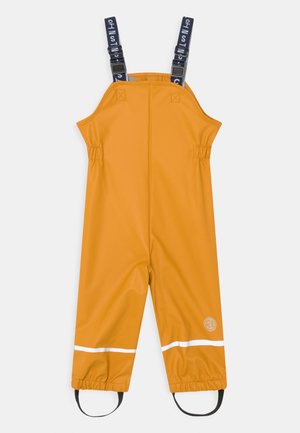 FIRST INSTINCT UNISEX - Rain trousers - gebranntes gelb