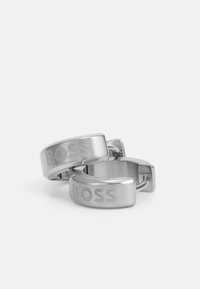 Silberhule cufflinks i rustfritt stål med børstet finish og gravert "BOSS"-logo. Rund form med polert kant og hengsel-lukking.