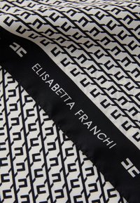 Silk scarf featuring a repeating geometric pattern in black and white, with a black label displaying the brand name "ELISABETTA FRANCHI."