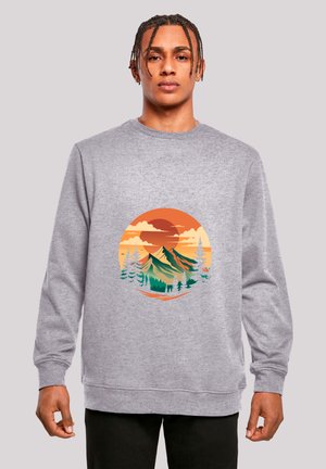 Gray sweatshirt with long sleeves, featuring a colorful mountain landscape graphic in a circular design at the center.