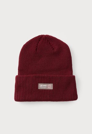 Burgundy knit beanie, featuring a folded cuff and a woven label. Material has a textured pattern, creating a cozy appearance.