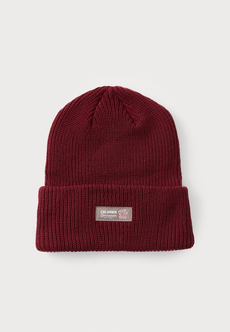 Burgundy knit beanie, featuring a folded cuff and a woven label. Material has a textured pattern, creating a cozy appearance.