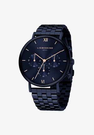 Marineblauwe metalen horloge met een ronde wijzerplaat, drie sub-dials, gouden accenten voor uur markeringen en een schakelarmband.