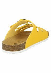 Yellow slide sandal with cut-out design, cork footbed, and white rubber sole. Features soft upper material and black hardware accents.