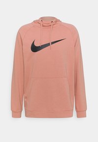 Sweat à capuche rose avec un logo Nike noir, doté d'une capuche à cordon, d'une poche frontale et de poignets et ourlet côtelés. Confectionné en tissu doux.