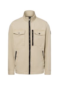 Beige Jacke mit Stehkragen, schwarzem Reißverschluss und zwei Brusttaschen. Aus leichtem Stoff mit einer leicht gewellten Textur gefertigt.