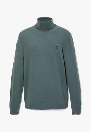 Polotröja i mörkgrönt bomullsblandning. Har långa ärmar, ribbade muddar och en liten logga på bröstet. Särpräglad textur.