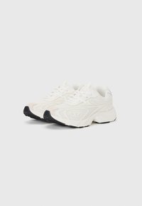 White textile sneakers with mesh panels, textured lower section, and a black rubber outsole. Features round laces and a soft, cushioned design.