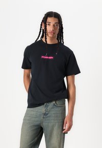 Black cotton T-shirt with a crew neckline and short sleeves, featuring a prominent pink "FORMER" logo at the center.
