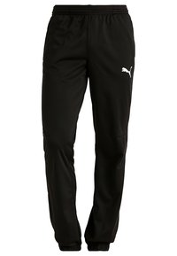 Svart idrottsbyxor tillverkade av slät tyg med resårmidja, avsmalnande ben och vita Puma-logotillbehör på sidan.