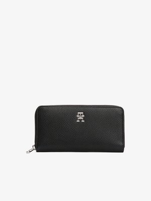 Black pebbled leather wallet with zip closure, featuring a silver logo emblem. Rectangular shape with textured surface and sturdy stitching.