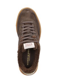 Brown suede sneaker with a textured upper, faux fur lining, and a gum rubber sole; features flat laces and a logo tag on the tongue.