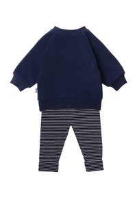 Navy sweatshirt with round neckline and ribbed cuffs paired with navy and white striped leggings, featuring a tapered leg and cuffed hem.