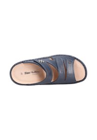 Blue leather slide sandal featuring three wide straps, an open toe, and a tan cushioned insole with a small decorative flower detail.