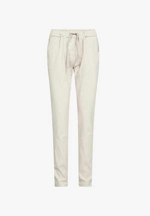 Beežid vabaaja püksid elastse vöökohaga, nöörlindiga ja küljetaskutega, kitseneva säärekujundusega valgel taustal.