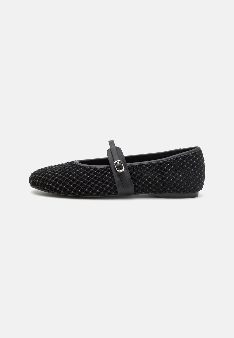 Black ballet flats with a textured mesh upper, featuring a thin black strap with a decorative silver buckle across the instep. Soft sole.