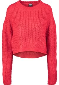 Pull épais tricoté rouge vif avec manches longues, col rond et ourlet légèrement raccourci.